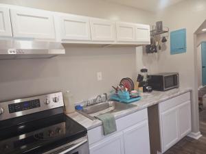 a kitchen with a sink and a stove at Comfy 1BR Apt. in Pleasant Ridge in Cincinnati