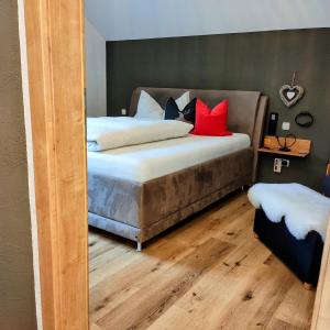 a bedroom with a large bed with red pillows at Chalet Catina - Kärnten Card im Sommer inklusive - in Bad Kleinkirchheim +38 photos