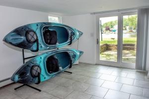 two kayaks on display in a room with a window at New Renovated vacation house in Brady Park
