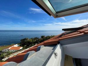a view of the ocean from the roof of a building at Charmant petit appartement vue mer et corniche Esterel in Anthéor
