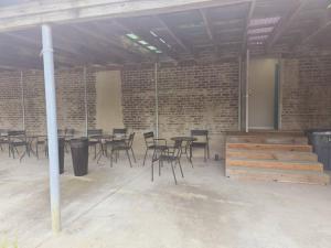 a room with tables and chairs in a brick building at Comfy 1BR Apt. in Pleasant Ridge in Cincinnati