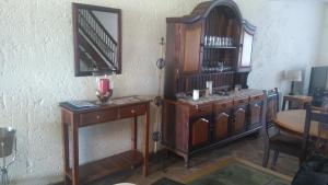 a room with wooden furniture and a mirror on the wall at Green Fountain Villa 5 in Port Alfred