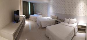 Llit o llits en una habitació de Nobile Hotel Convention Ciudad Del Este