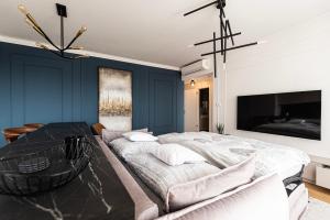 a bedroom with a large bed and a table at Klingerka Apartment, 25th floor with Free parking and view of Castle and Danube in Bratislava