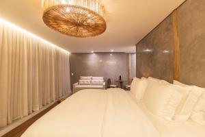 Ein Bett oder Betten in einem Zimmer der Unterkunft Yemanjá Hotel by Preabeach Experience