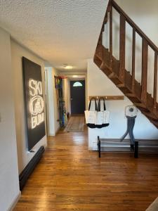 a hallway with a staircase and a bench in a house at Ski Town Chalet in Steamboat Springs
