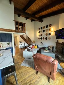 a living room with a couch and a table at Ski Town Chalet in Steamboat Springs