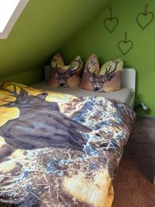 a bedroom with a bed with a dragon comforter at Harzlicht Braunlage - mit Balkon und Weitblick in Braunlage +12 photos