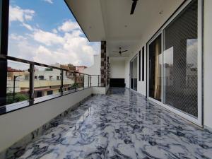 a balcony with a marble floor and windows at Chitrangan The Homestay of Udaipur in Udaipur +50 photos