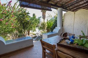 a patio with a table and chairs and trees at Casa Pompelmo in Lipari