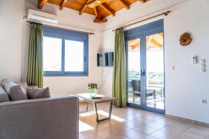 a living room with a couch and a table at Nenes House in Koroni