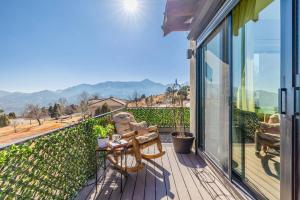 a patio with a table and chairs on a balcony at Cathedral Spires Luxury Home Tucked in the MTN'S in Colorado Springs