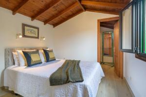 une chambre avec un lit dans une pièce avec des plafonds en bois dans l'établissement Estudio Tegoyo, à Mácher 25 autres photos