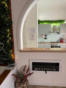 a white kitchen with a fireplace and a window at Sweet Dreams Rooms in Brindisi