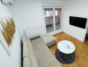 a living room with a couch and a table at Apartman Lilly - Zagreb - Mirna Lokacija - Lođa in Zagreb