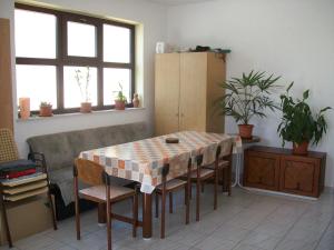 a dining room with a table and chairs in a room at Rooms MUDRAC in Senj