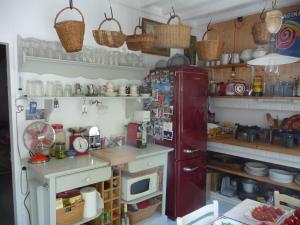 a kitchen with a red refrigerator and a microwave at Chaleureuse chambre double avec accès jardin, WiFi et animaux admis - FR-1-590-490 in Presnoy