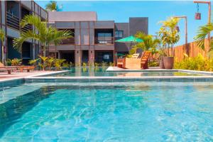a large swimming pool in front of a building at Patacho Porto Gamboa in Pôrto de Pedras