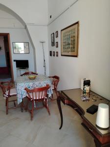 a dining room with a table and chairs and a table and a tableablish at Casa Vacanze Silvia in Pizzo