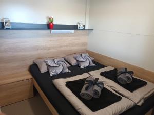 a bed with towels and shoes on top of it at Mobile Home L&L in Drage