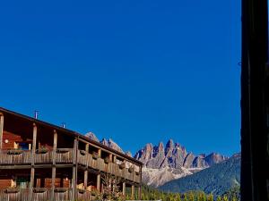 a building with a view of mountains in the background at Oberprantschöllhof - Horse Mountain Stable in Bressanone