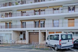 a white van parked in front of a building at La confidence in Périgueux