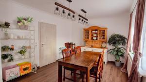 a kitchen with a wooden table and a dining room at Villa Wundervoll in Dahlen