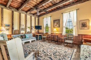 a living room with a couch and a table at Historic Bliss on Pawleys Island's Shoreline in Pawleys Island