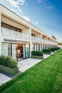 an exterior view of a building with a lawn at Lion PARKK Apartments in Kníničky