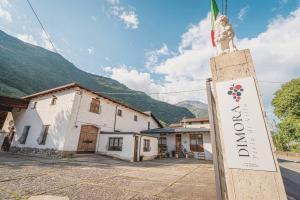 a sign for a hotel in front of a building at Dimora Perla di Villa - Historical Wine Retreat near Bernina Express in Villa di Tirano