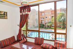 a living room with a couch and a large window at MOHAMMEDIA Rico Flores in Mohammedia