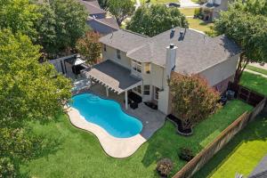 an aerial view of a house with a swimming pool at The staycation, 4 beds-3 baths, with pool and hot tub near AT&T stadium, 20 mins to Dallas and Fort Worth in Grand Prairie