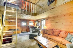 ein Wohnzimmer mit einem Sofa und einer Holzwand in der Unterkunft Warren Vacation Rental about 3 Mi to Sugarbush Resort! in Warren