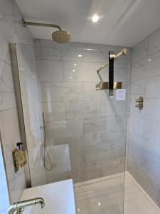 a bathroom with a shower with a glass door at Perfect Getaway 2 in Middlesbrough +19 photos