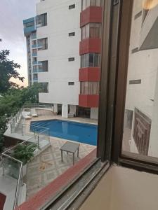 a view of a swimming pool from a window at Edificio Perla Del Caribe in Gaira +6 photos