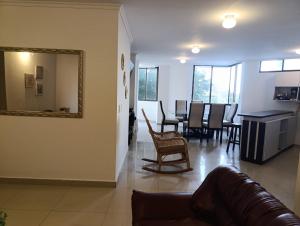 a living room with a couch and a mirror at Edificio Perla Del Caribe in Gaira