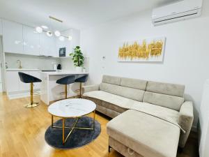 a living room with a couch and a table at Apartman Lilly - Zagreb - Mirna Lokacija - Lođa in Zagreb