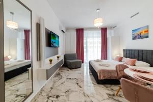 En eller flere senge i et værelse på Lexxa 4 Casa Del Mar -Mamaia Nord