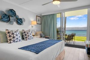 a bedroom with a bed and a view of the ocean at Napili Shores I174 in Kapalua