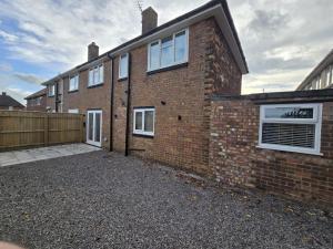 a brick house with white windows and a fence at Perfect Getaway 2 in Middlesbrough