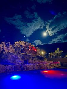 a nightime view of a pool with the moon at Hotel Casa Cantabria Campestre in Villa de Leyva