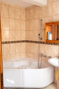 a bath tub in a bathroom with a sink at Old Town Villa Sarajevo in Sarajevo +23 photos