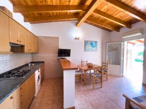 a kitchen with a table and a dining room at Can Pep Yern 3 in Playa Migjorn