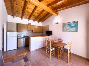 a kitchen and dining room with a table and chairs at Can Pep Yern 3 in Playa Migjorn