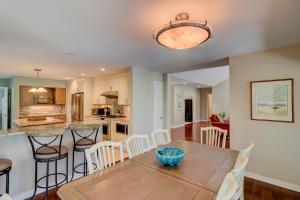 a kitchen and dining room with a wooden table and chairs at Fairway Oasis in Hilton Head Island +37 photos