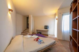 a bedroom with a bed with flowers on it at La Casa nel Borgo Lake View - Happy Rentals in Nebbiuno +24 photos