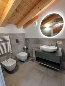 a bathroom with two sinks and a toilet and a mirror at Casa Larius in Como +37 photos