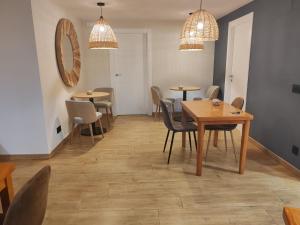 a dining room with tables and chairs and lights at Amillano Rural Suites - Adults only in Amillano