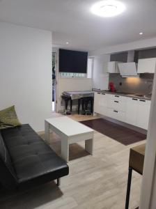 a kitchen and living room with a couch and a table at el rincón de florida in Vigo +5 photos