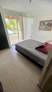 a bedroom with a bed and a large window at Residencial Terrasol Villa 342 in Acapulco